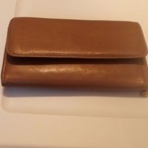Tan leather wallet and burgundy jewelry travel bag